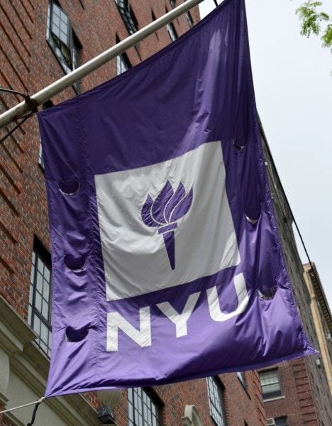 A flag flies from a building at New York University May 4, 2012 in New York. Chinese activist Chen Guangcheng has been invited to study at New York University, a spokesman for the institution said, as efforts to resolve a US-Chinese diplomatic crisis appeared nearer to success. "Chen Guangcheng has long-established relationships with faculty at the NYU School of Law, and has an invitation to be a visiting scholar at NYU -- either in New York or at one of our other global sites," spokesman John Beckman said in a statement. AFP PHOTO/Stan HONDA        (Photo credit should read STAN HONDA/AFP/GettyImages)